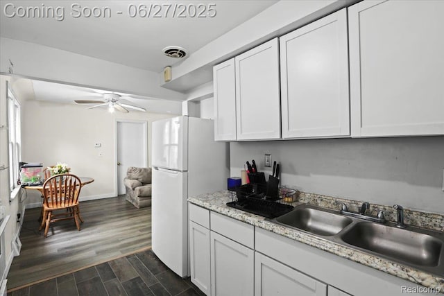 166 W Milton Ave, Oak Park, MI 48030 - kitchen with a ceiling fan, white cabinets, dark wood-style floors, and freestanding refrigerator