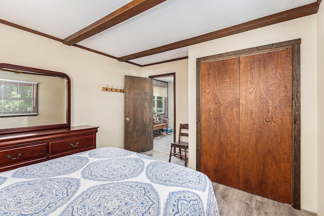 5510 W Lattin Rd, Pentwater, MI 49449 - bedroom with light wood-style floors, a closet, and beam ceiling