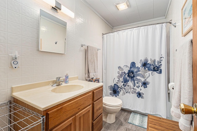 5510 W Lattin Rd, Pentwater, MI 49449 - full bath with tile walls, vanity, wood finished floors, shower / tub combo with curtain, and crown molding