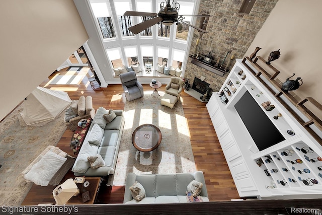 5001 Forest Vly, Clarkston, MI 48348 - living room with a ceiling fan, a fireplace, wood finished floors, and a towering ceiling