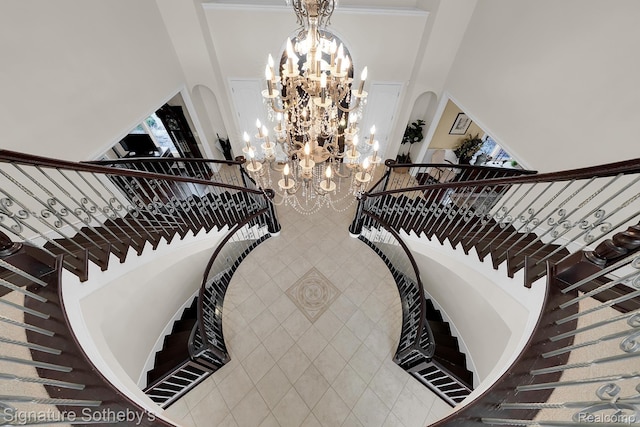 5001 Forest Vly, Clarkston, MI 48348 - stairs with a towering ceiling, a chandelier, and arched walkways