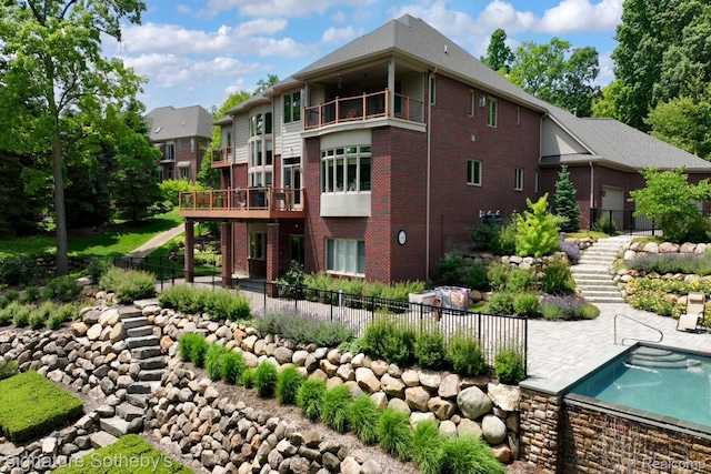 5001 Forest Vly, Clarkston, MI 48348 - back of house featuring stairway, brick siding, a patio area, and a balcony