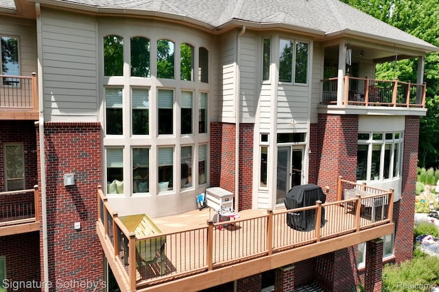 5001 Forest Vly, Clarkston, MI 48348 - back of property with a balcony, brick siding, roof with shingles, and a wooden deck