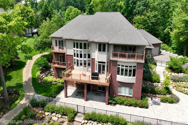 5001 Forest Vly, Clarkston, MI 48348 - back of house with a balcony, a patio area, a fenced backyard, and brick siding