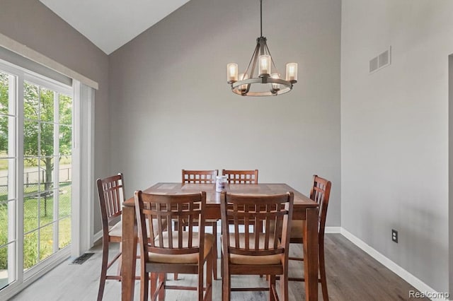 70298 Sunny Brook Ln, Macomb, MI 48062 - dining space featuring wood finished floors, a chandelier, and vaulted ceiling