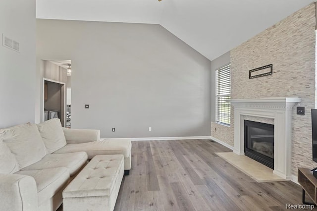 70298 Sunny Brook Ln, Macomb, MI 48062 - living area featuring high vaulted ceiling, wood finished floors, a glass covered fireplace, and a ceiling fan