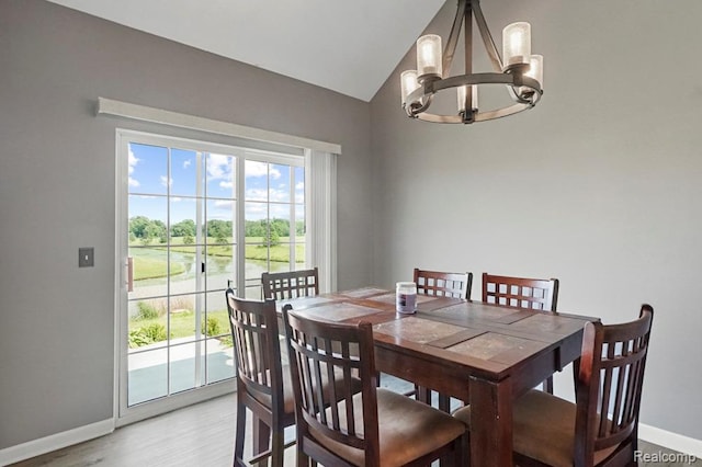 70298 Sunny Brook Ln, Macomb, MI 48062 - dining area with a chandelier, light wood finished floors, and vaulted ceiling