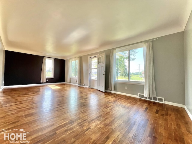 10306 Reid Rd, Swartz Creek, MI 48473 - empty room featuring wood finished floors and baseboards