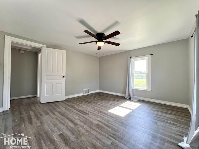 10306 Reid Rd, Swartz Creek, MI 48473 - unfurnished bedroom with dark wood finished floors, attic access, and ceiling fan