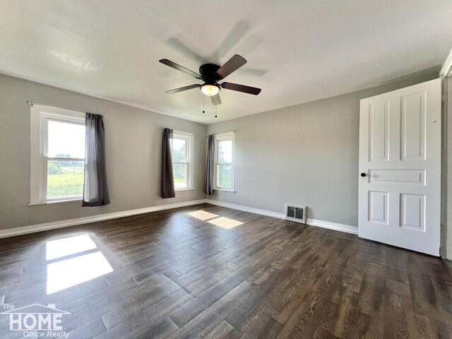10306 Reid Rd, Swartz Creek, MI 48473 - spare room featuring healthy amount of natural light, ceiling fan, and dark wood finished floors