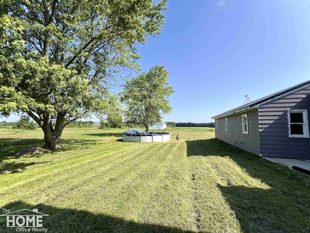 10306 Reid Rd, Swartz Creek, MI 48473 - view of green lawn featuring a covered pool and a view of rural / pastoral area