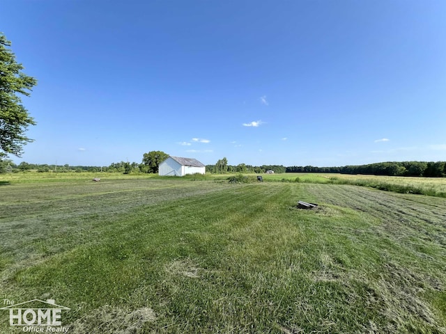 10306 Reid Rd, Swartz Creek, MI 48473 - view of green lawn featuring a view of rural / pastoral area and an outdoor structure