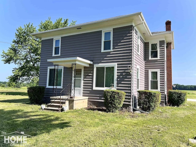 10306 Reid Rd, Swartz Creek, MI 48473 - traditional style home with a front lawn and a chimney