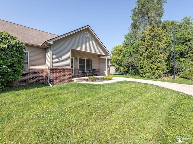 5257 Torrington Dr, Monroe, MI 48161 - view of front of house with brick siding, a front lawn, roof with shingles, and an attached garage