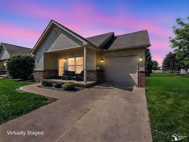 5257 Torrington Dr, Monroe, MI 48161 - view of front of house with brick siding, a front lawn, a garage, and driveway