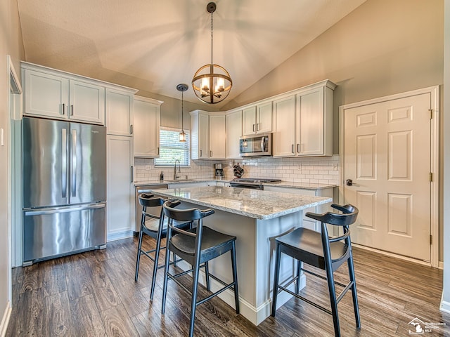 5257 Torrington Dr, Monroe, MI 48161 - kitchen with appliances with stainless steel finishes, lofted ceiling, dark wood-type flooring, a chandelier, and decorative backsplash