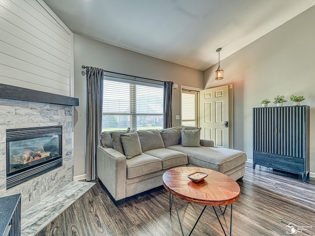 5257 Torrington Dr, Monroe, MI 48161 - living room featuring lofted ceiling, dark wood-type flooring, and a glass covered fireplace