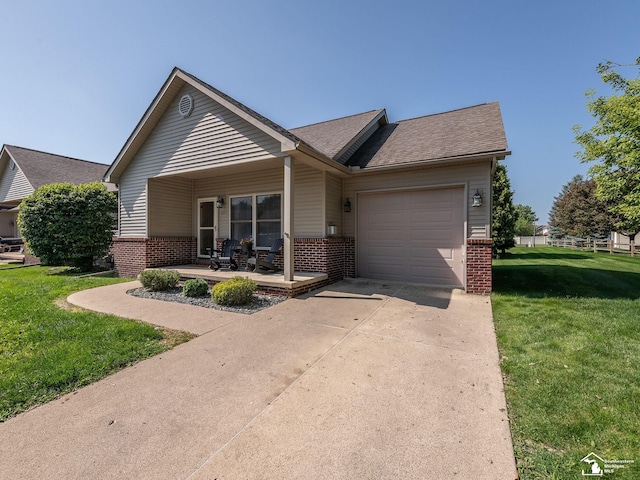 5257 Torrington Dr, Monroe, MI 48161 - view of front of house with brick siding, a garage, a front yard, and concrete driveway
