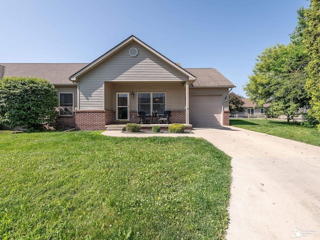 5257 Torrington Dr, Monroe, MI 48161 - view of front of property with brick siding, a garage, driveway, and a front lawn