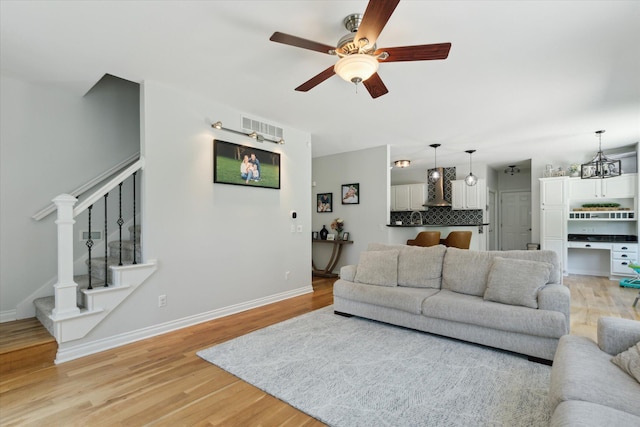 6212 Sagamore Ln, Kalamazoo, MI 49004 - living area featuring stairway, ceiling fan, and light wood finished floors