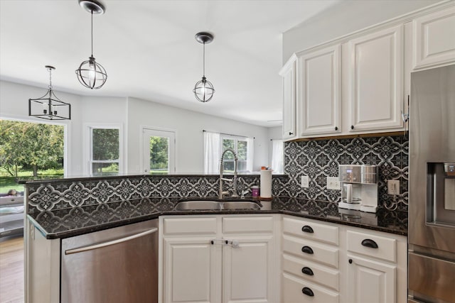 6212 Sagamore Ln, Kalamazoo, MI 49004 - kitchen featuring appliances with stainless steel finishes, tasteful backsplash, dark stone counters, and white cabinets