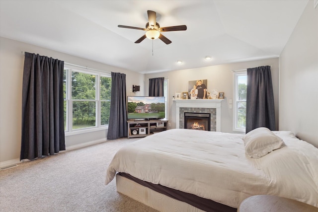 6212 Sagamore Ln, Kalamazoo, MI 49004 - bedroom with carpet floors, lofted ceiling, a tiled fireplace, and ceiling fan