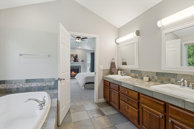 6212 Sagamore Ln, Kalamazoo, MI 49004 - full bath with double vanity, vaulted ceiling, ceiling fan, a bath, and ensuite bathroom