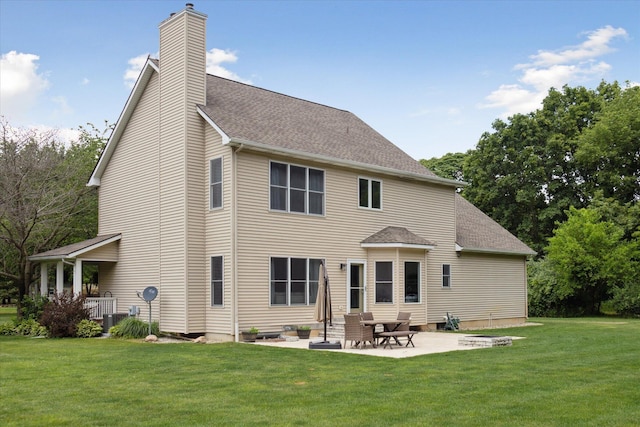 6212 Sagamore Ln, Kalamazoo, MI 49004 - back of property with a shingled roof, a lawn, a chimney, and a patio area