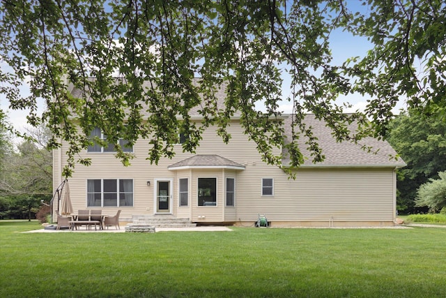6212 Sagamore Ln, Kalamazoo, MI 49004 - back of property with a lawn, a patio, and roof with shingles