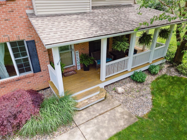 6212 Sagamore Ln, Kalamazoo, MI 49004 - entrance to property featuring a shingled roof, a porch, and brick siding