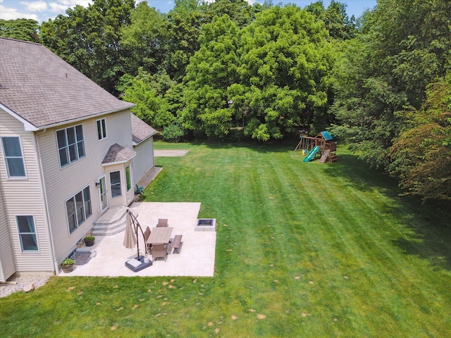 6212 Sagamore Ln, Kalamazoo, MI 49004 - view of grassy yard with a playground and a patio