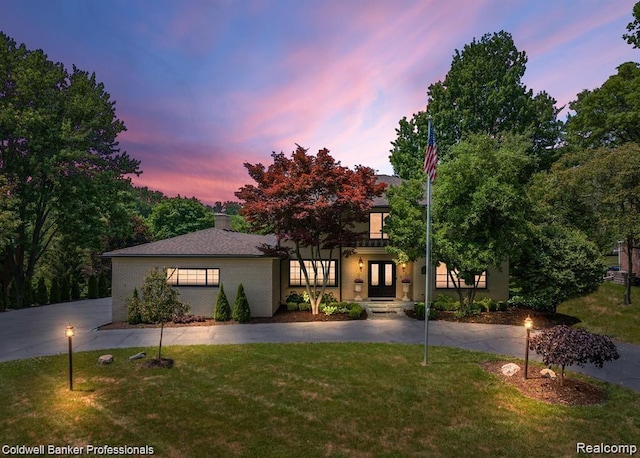 4462 Barchester Dr, Bloomfield Hills, MI 48302 - view of front of house with french doors, a front yard, and brick siding
