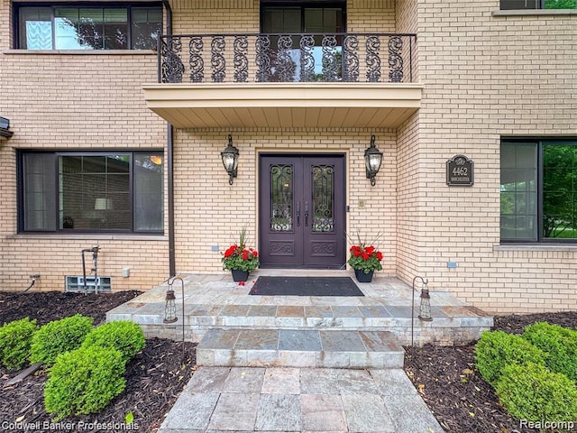 4462 Barchester Dr, Bloomfield Hills, MI 48302 - view of exterior entry featuring french doors, a balcony, and brick siding