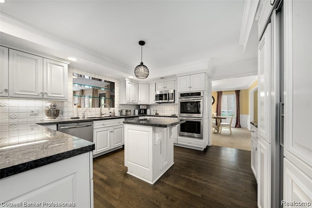 4462 Barchester Dr, Bloomfield Hills, MI 48302 - kitchen with stainless steel appliances, ornamental molding, dark wood-style floors, tasteful backsplash, and white cabinetry