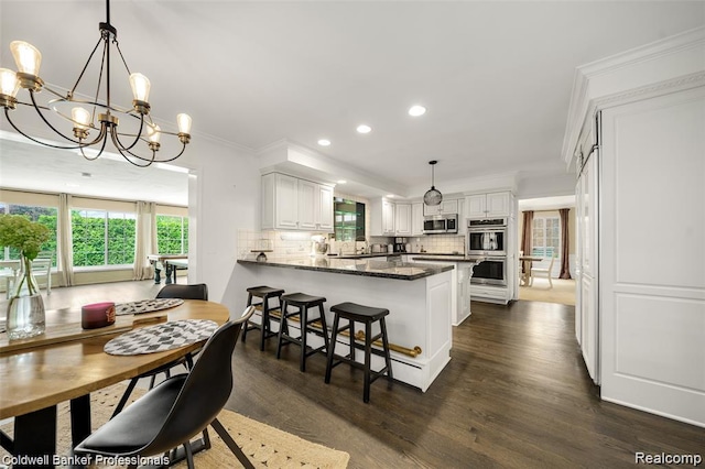 4462 Barchester Dr, Bloomfield Hills, MI 48302 - dining space with recessed lighting, a chandelier, dark wood-type flooring, and ornamental molding