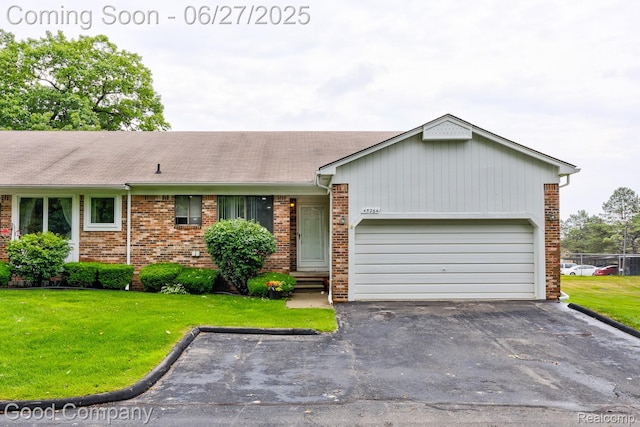 45264 Universal Ct, Shelby Twp, MI 48317 - single story home with brick siding, driveway, a garage, and a front lawn
