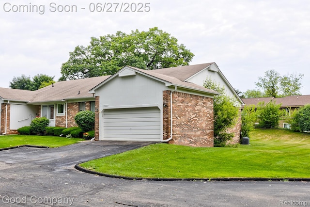 45264 Universal Ct, Shelby Twp, MI 48317 - ranch-style house featuring brick siding, a garage, driveway, and a front yard