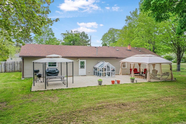 205 Alexander St, Cadillac, MI 49601 - back of house with a gazebo, a patio, and a shingled roof