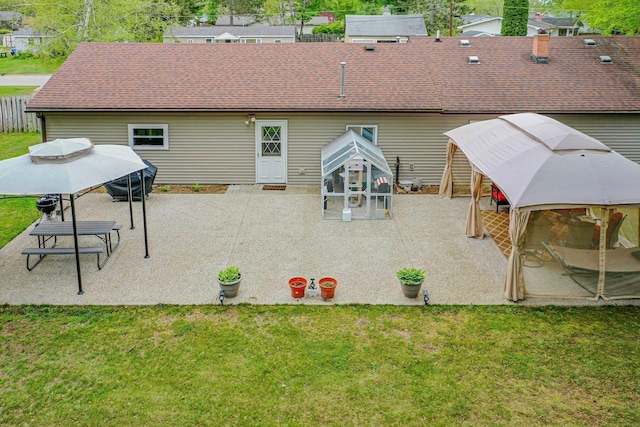 205 Alexander St, Cadillac, MI 49601 - back of property featuring a gazebo, a lawn, and a patio