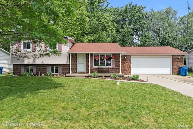 4438 Bridgeman Trl, Swartz Creek, MI 48473 - tri-level home with driveway, an attached garage, a front yard, and brick siding