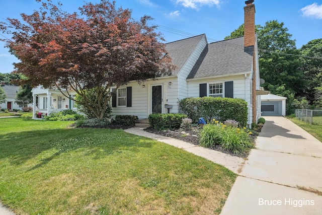 920 Graceland St NE, Grand Rapids, MI 49505 - view of front facade featuring a chimney, roof with shingles, an outbuilding, and a garage