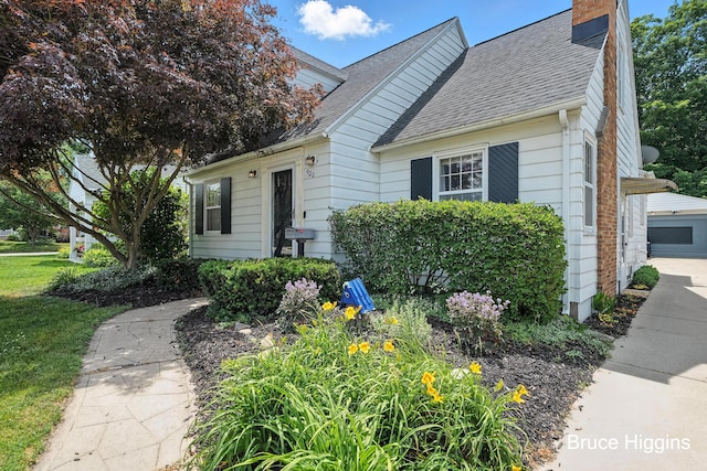920 Graceland St NE, Grand Rapids, MI 49505 - view of front facade featuring roof with shingles and a chimney