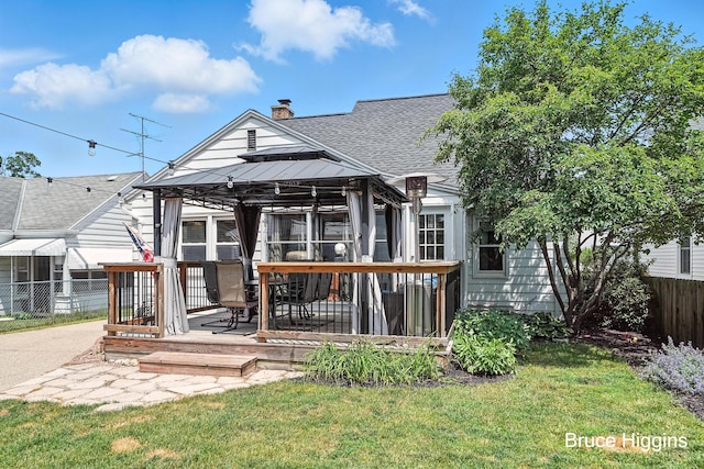 920 Graceland St NE, Grand Rapids, MI 49505 - back of house with a gazebo, a shingled roof, a chimney, and a wooden deck