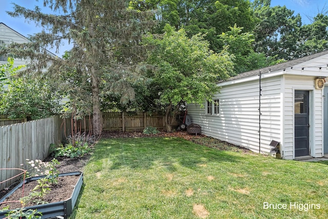 920 Graceland St NE, Grand Rapids, MI 49505 - fenced backyard with an outdoor structure and a vegetable garden