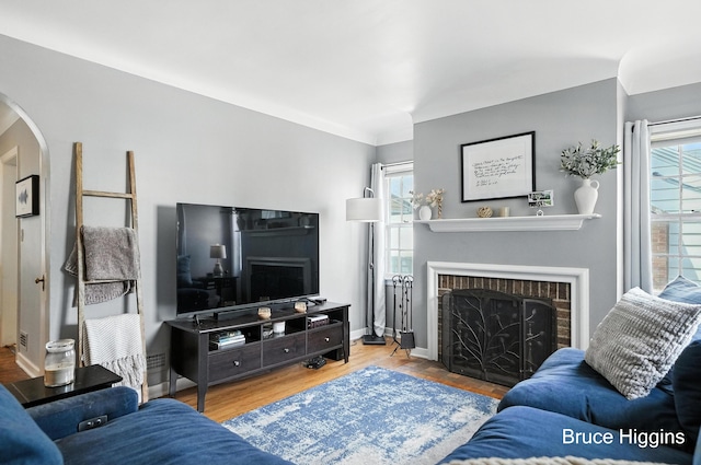 920 Graceland St NE, Grand Rapids, MI 49505 - living room with a brick fireplace, arched walkways, and wood finished floors