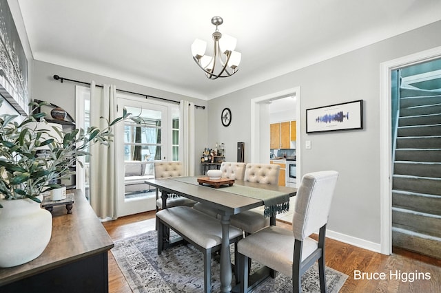 920 Graceland St NE, Grand Rapids, MI 49505 - dining space featuring stairway, wood finished floors, and a chandelier