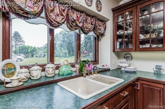 31085 Estate Woods Ct, Farmington Hills, MI 48331 - kitchen with dark countertops, glass insert cabinets, and healthy amount of natural light