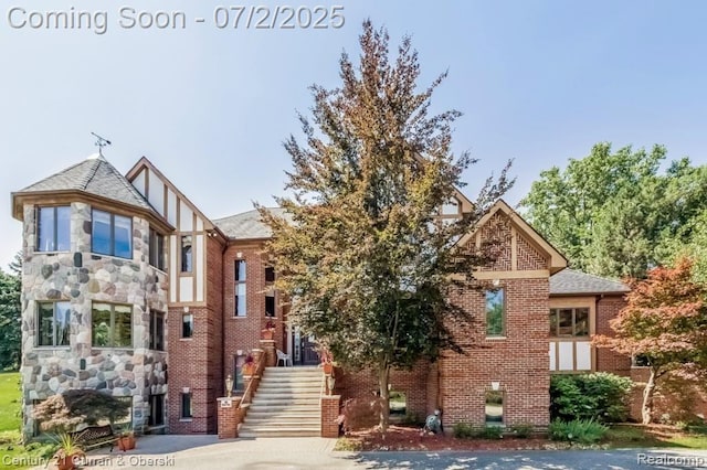 31085 Estate Woods Ct, Farmington Hills, MI 48331 - tudor-style house with brick siding and stone siding