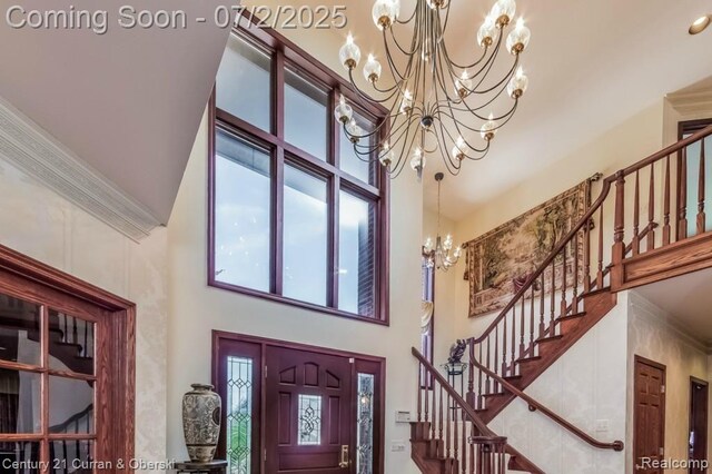 31085 Estate Woods Ct, Farmington Hills, MI 48331 - foyer entrance featuring a towering ceiling, a chandelier, plenty of natural light, stairway, and ornamental molding