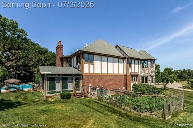 31085 Estate Woods Ct, Farmington Hills, MI 48331 - rear view of house featuring a sunroom, a chimney, brick siding, roof with shingles, and entry steps